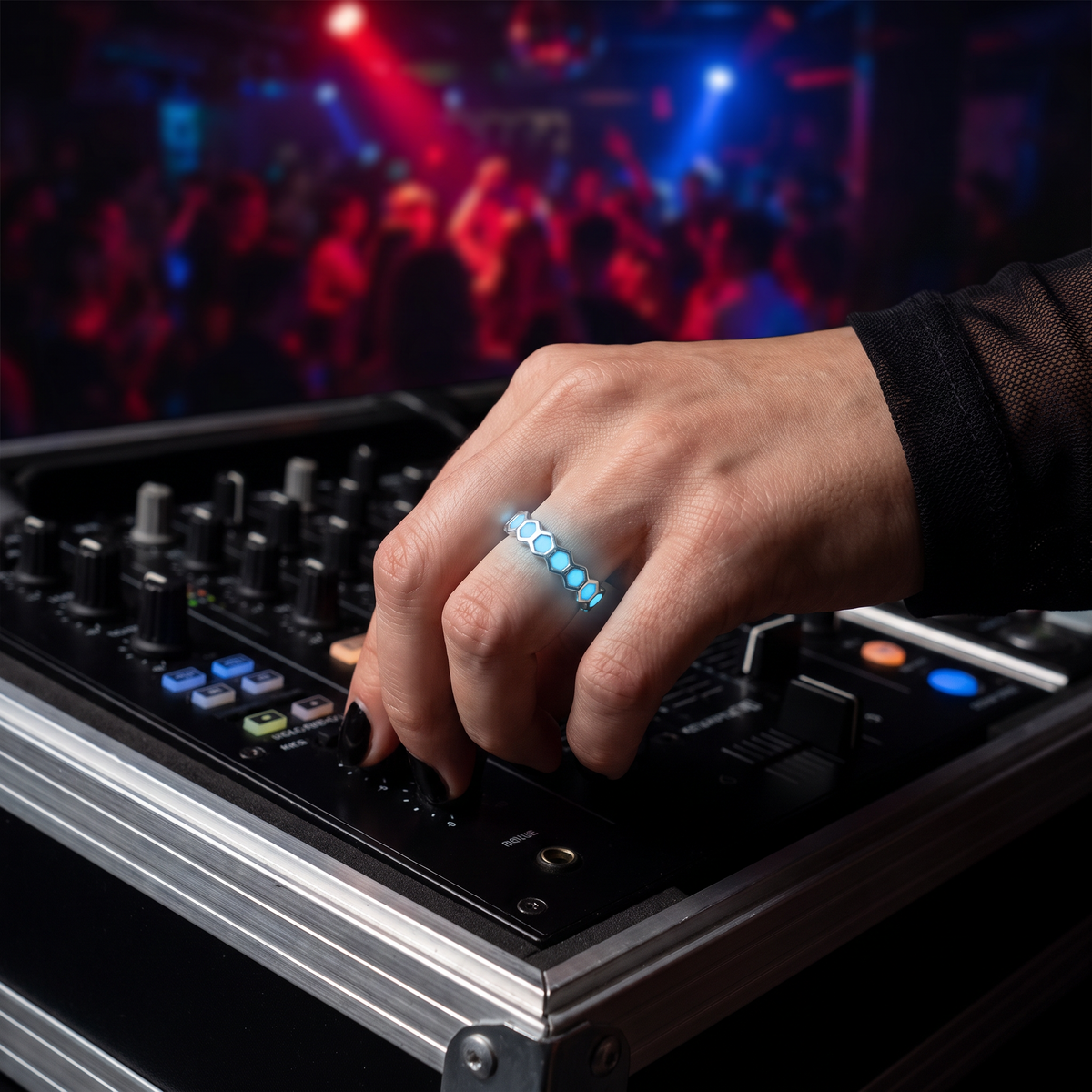 Luminous Honeycomb Ring worn at night. DJ booth, hand on the mixer.