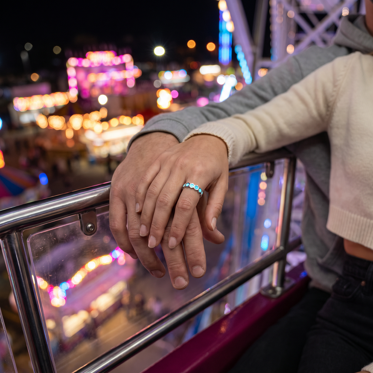 Luminous Honeycomb Ring worn at night. Ferris wheel, couple hands.