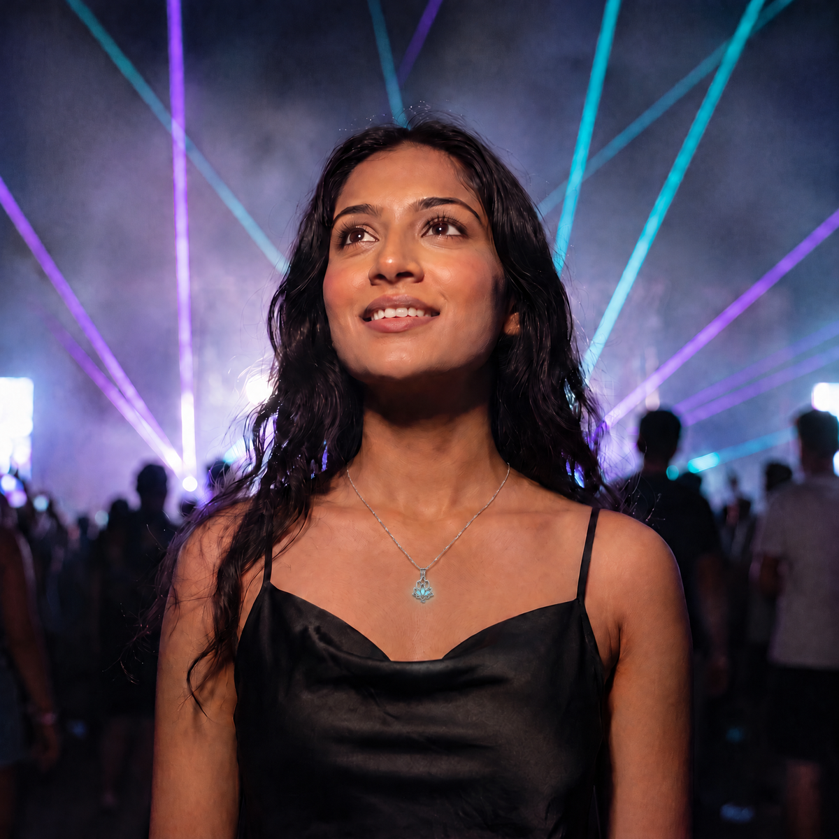 Luminous Lotus Necklace worn at night. Festival main stage, light blue glow.