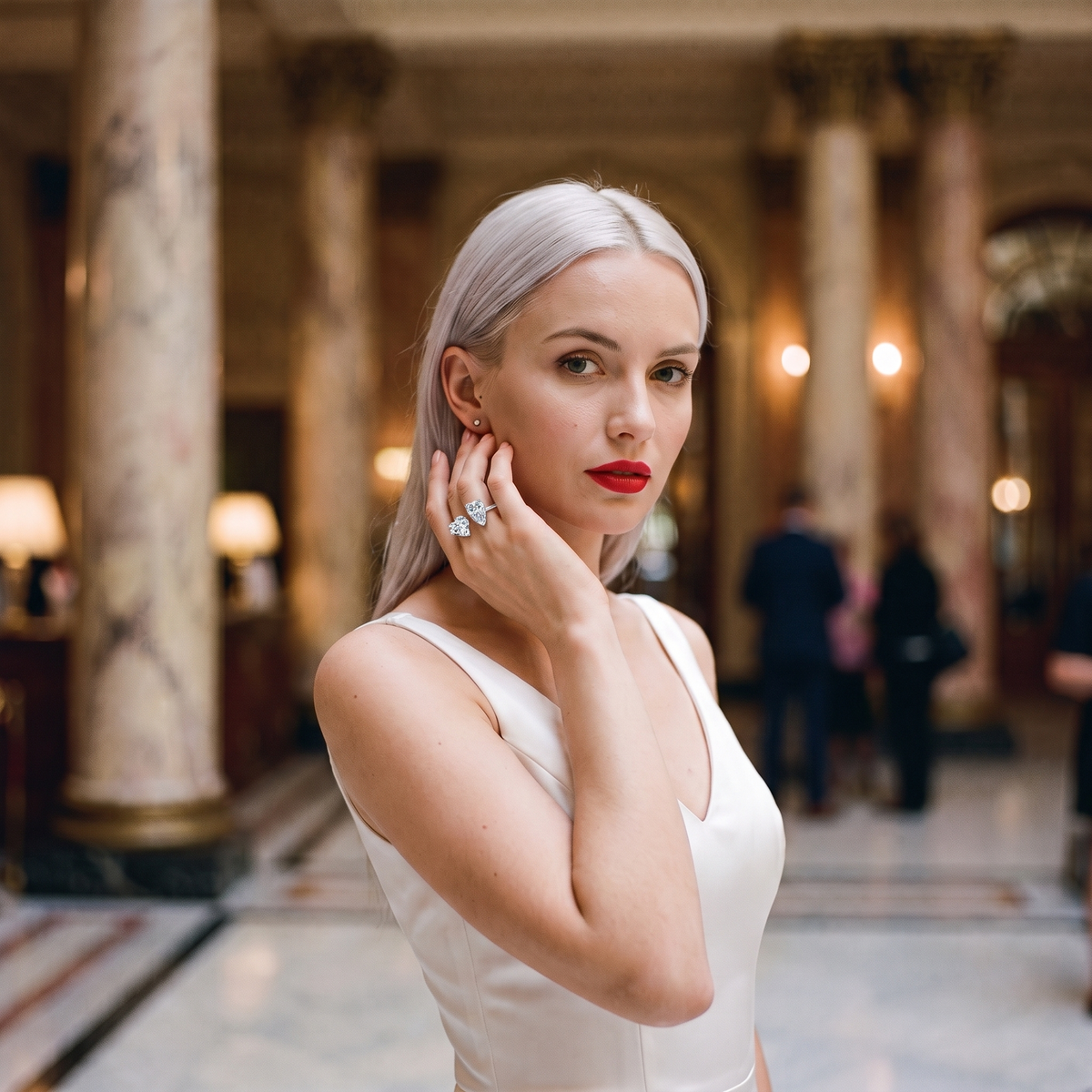 Aureole Moissanite Heart & Tear Ring worn in a marble hotel lobby