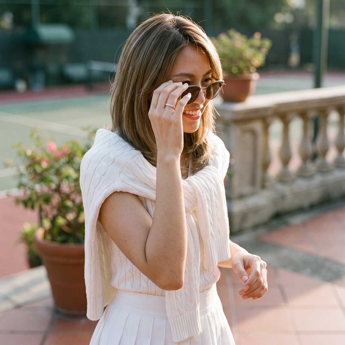 Aureole Moissanite Infinity Band Ring worn on a tennis club terrace