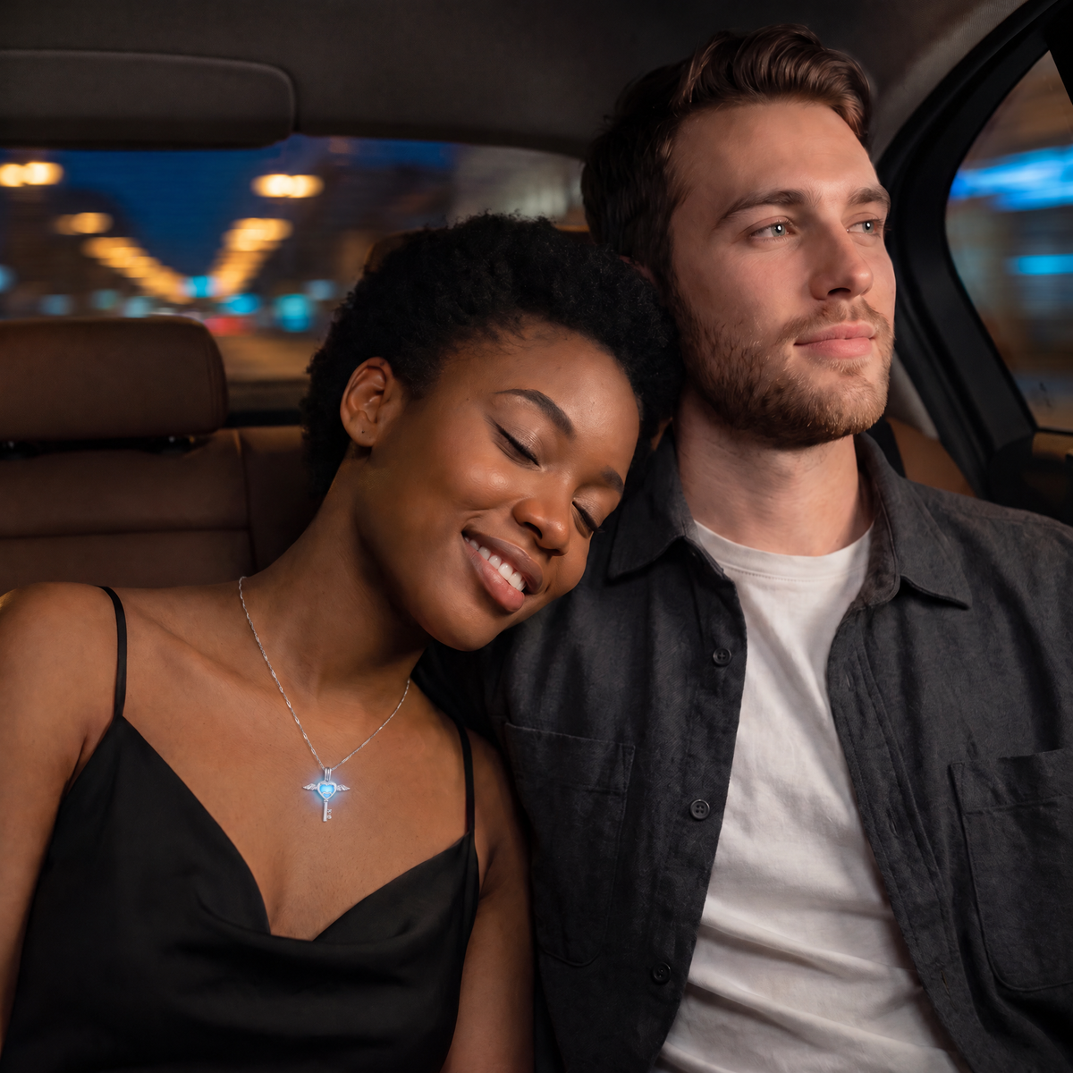 Luminous Love Key Necklace worn at night. Ride home, couple in the back seat.