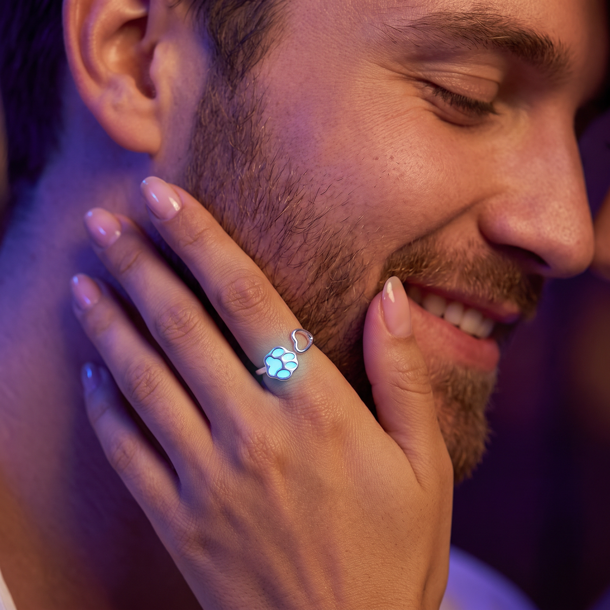 Luminous Dog Paw Ring worn at night. Club lounge, hand on his cheek.